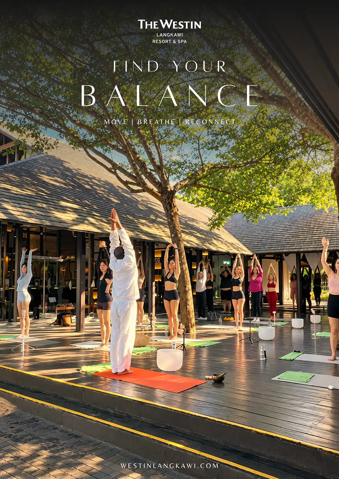Resort yoga session beneath a leafy tree in Langkawi
