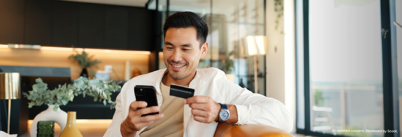 Person using a phone holding a card