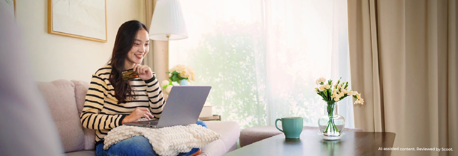 Woman using a laptop and credit card