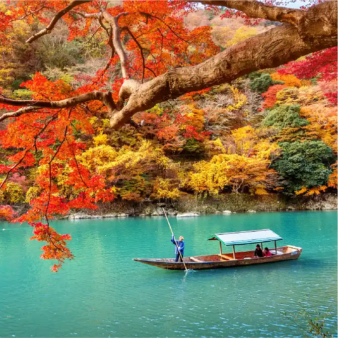 Boat ride on a river surrounded by autumn fall foliage